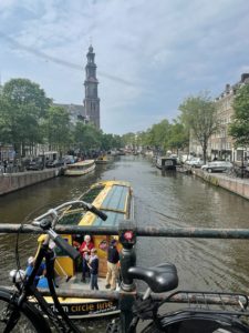 A beautiful Amsterdam canal boat cruising down the canal