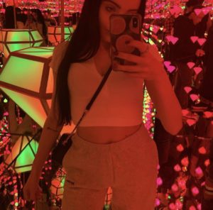 A picture of me surrounded by neon lights at the Moco Museum
