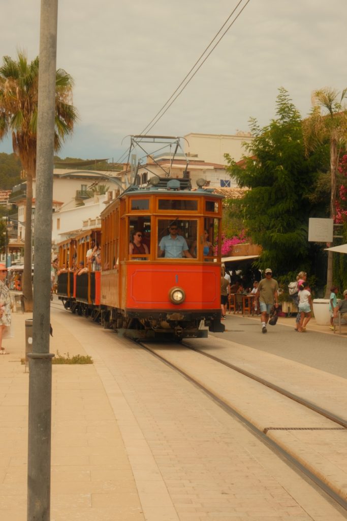 A vintage red and brown wooden tram in Soller, Mallorca - a true hidden gem.