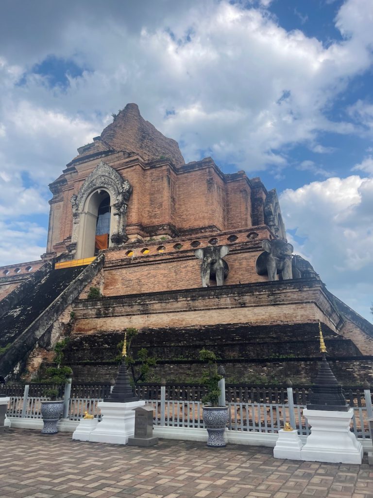 An old temple complex with elephants around its centre.