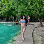 Posing next to the emerald blue water of Krabi's Emerald Pool