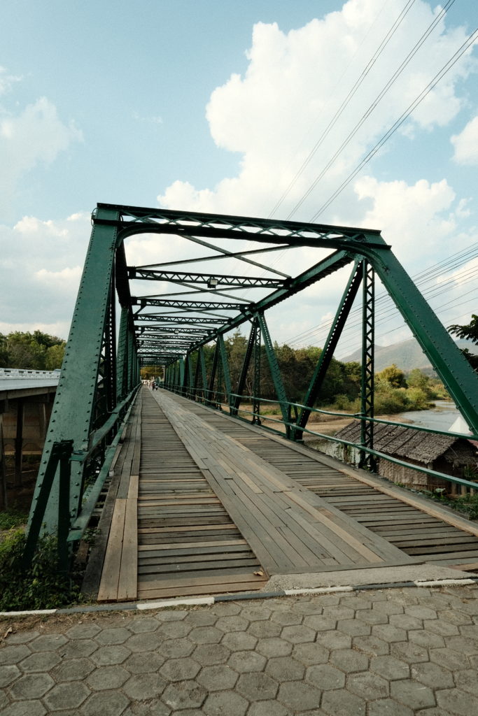 A green rustic looking bridge.