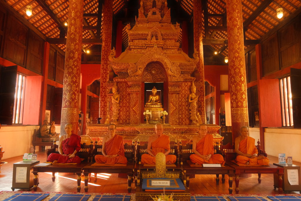 Statues of real life monks within a temple in Chiang Mai.