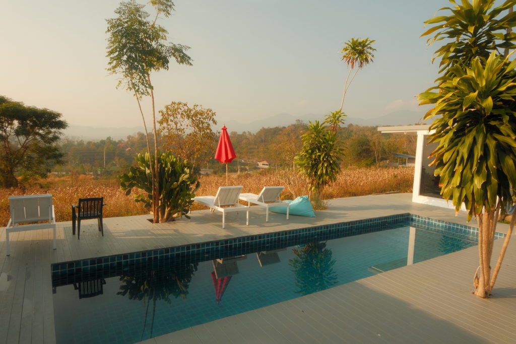 A pool overlooking the mountains on a clear sunny day.