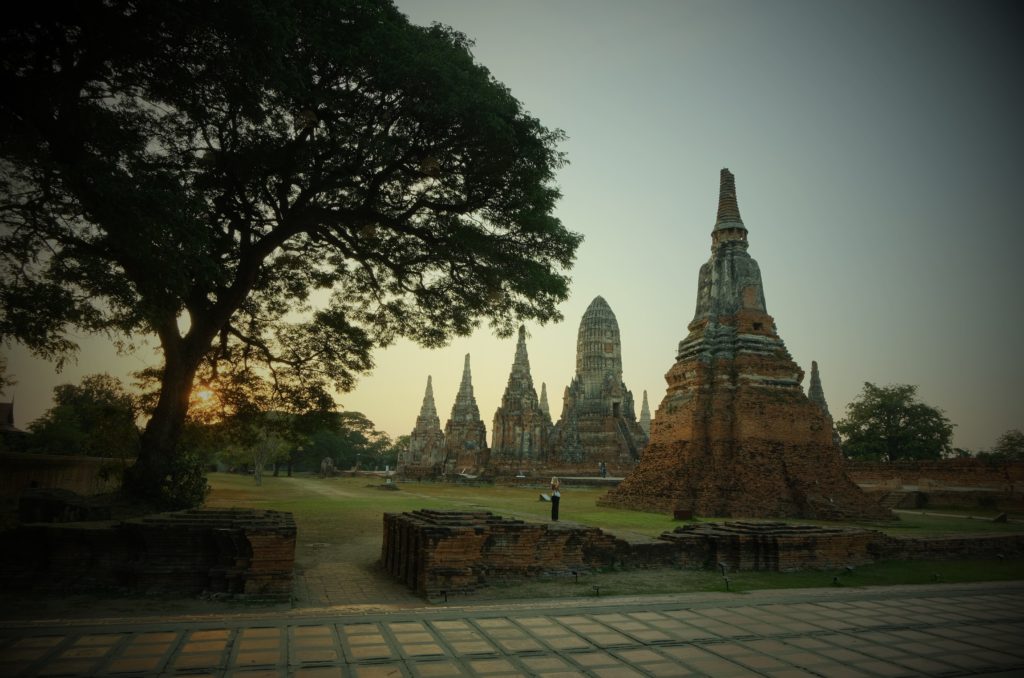 A grand view of an ancient temple complex at sunset.