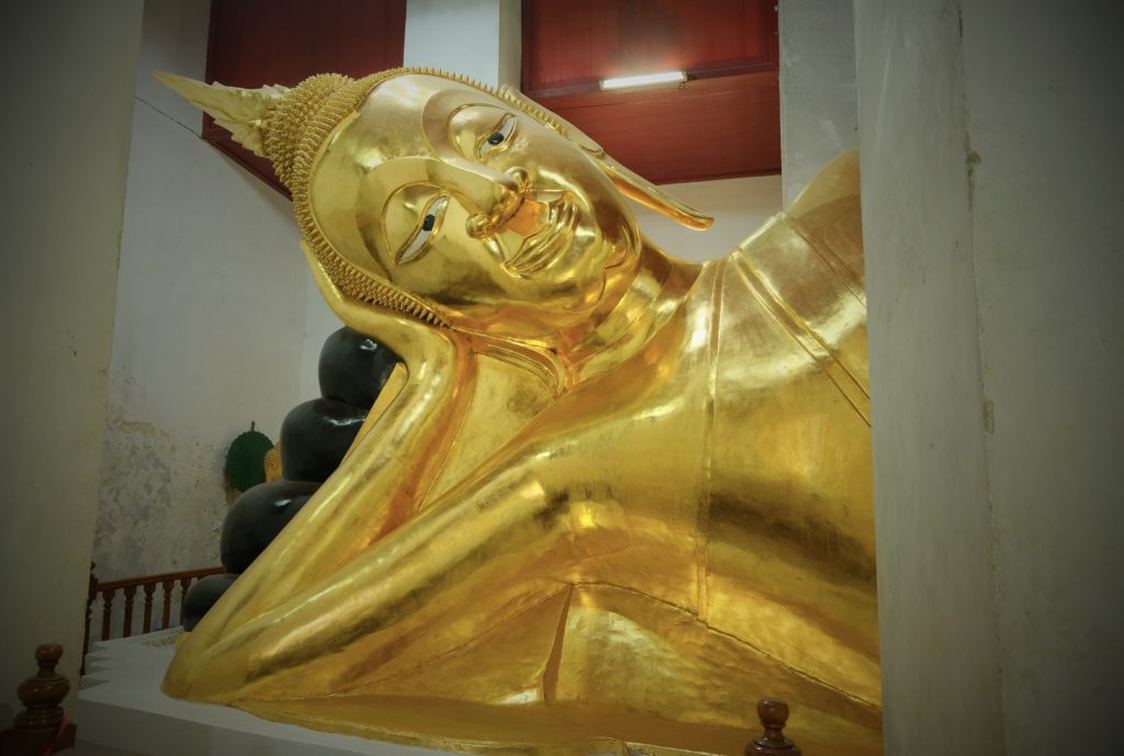 Large shiny golden reclining Buddha.