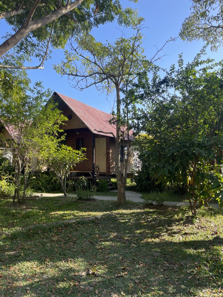 A small wooden hut accommodation on a farm in the North Thai countryside.