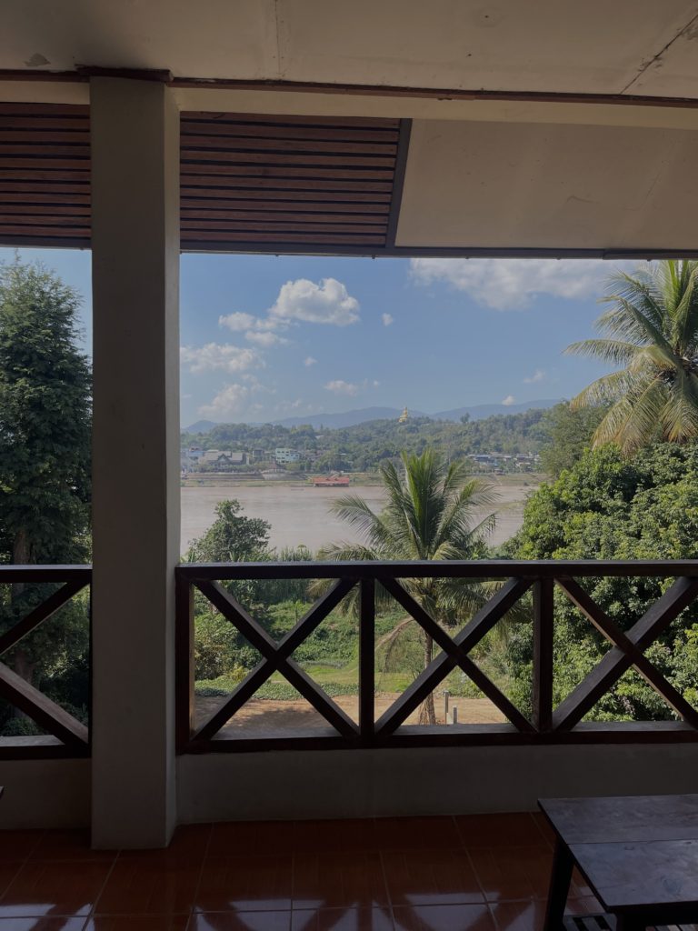 A pretty view of the Mekong River surrounded by vegetation on a bright sunny day.