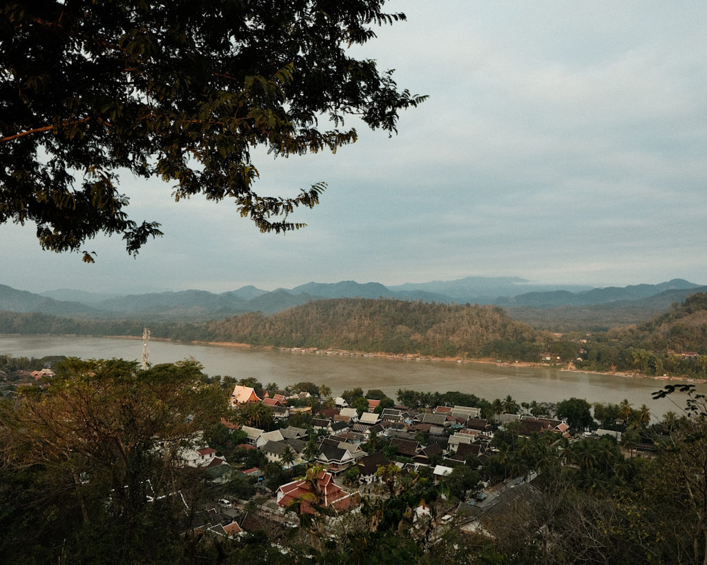 A 360 degree view over a village in a valley, surrounded by mountains.