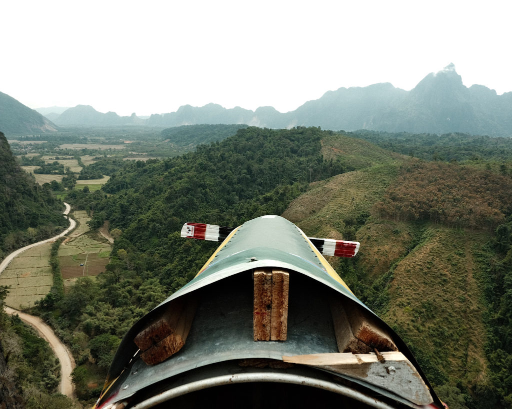 An incredible countryside view from a makeshift plane on top of a limestone cliff.
