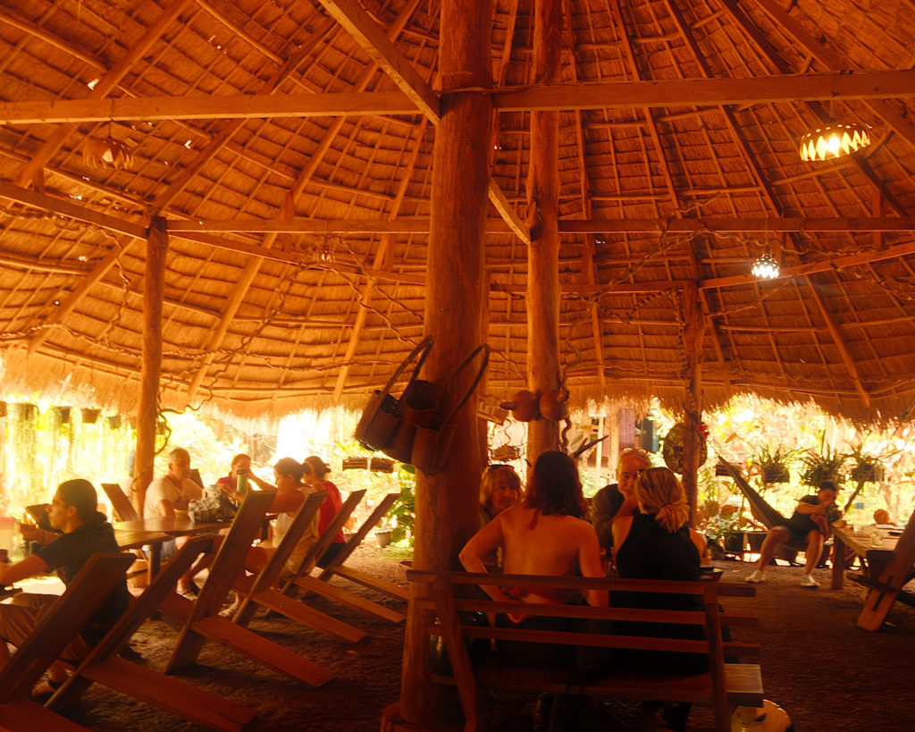 A wooden roof over an open air coffee shop.