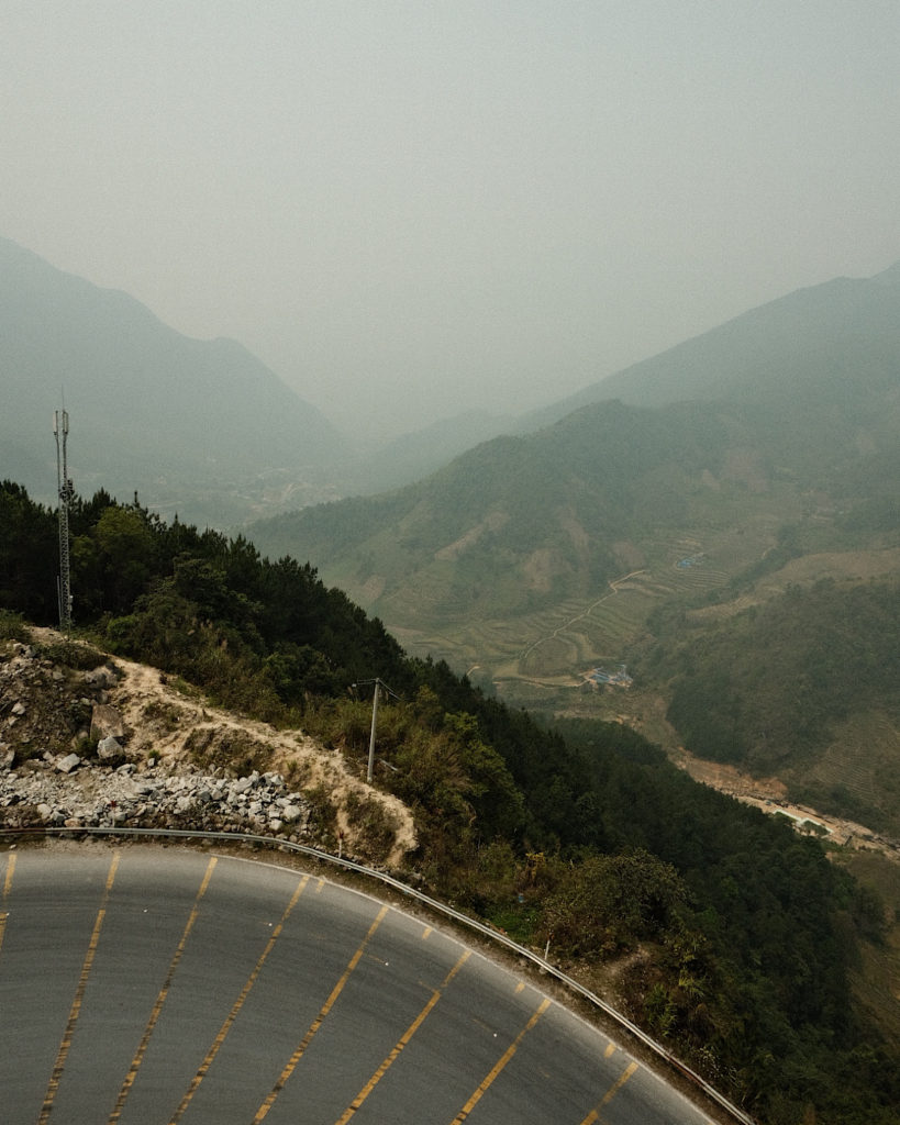 A sharp corner of a long winding highway pass through the mountains.