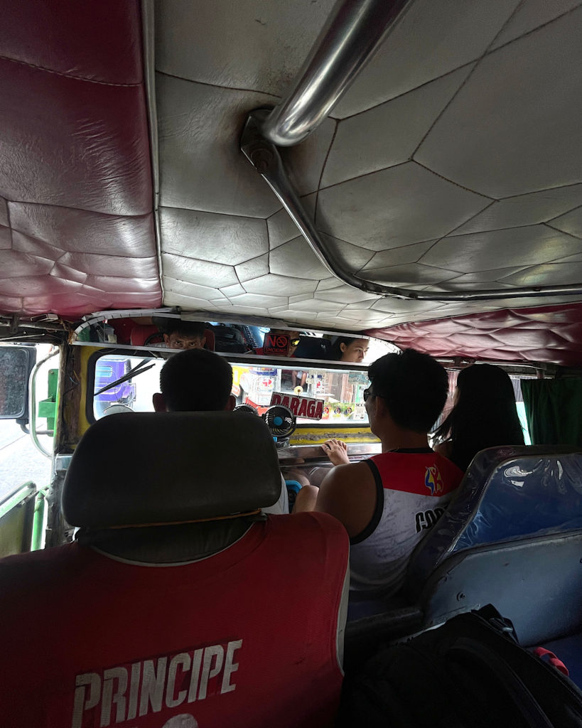 Traditional Filipino jeepney featuring crowded seating.