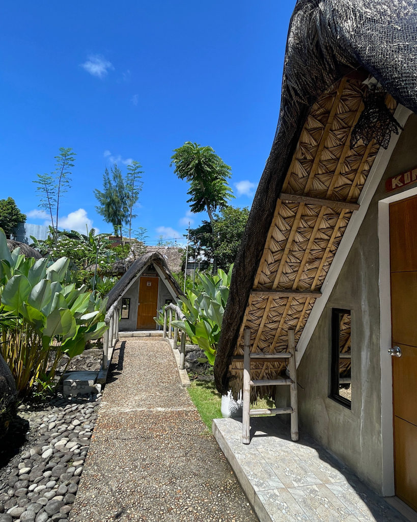 A characteristic bungalow with a thatched roof and wooden door.