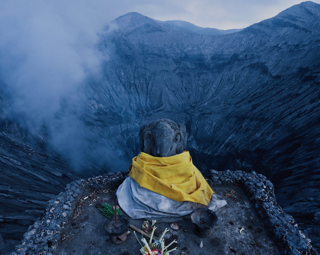 A statue of Ganesha on a volcanic crater amongst the scenic beauty of Mount Bromo.