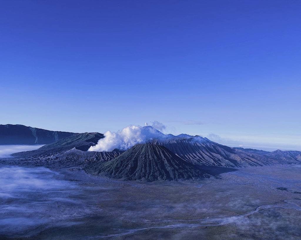 Mount Bromo engulfed in morning mist, creating a mystical setting.