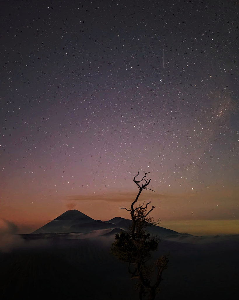 Stunning view of the Milky Way galaxy shining brightly above Mount Bromo, adorned with countless stars.