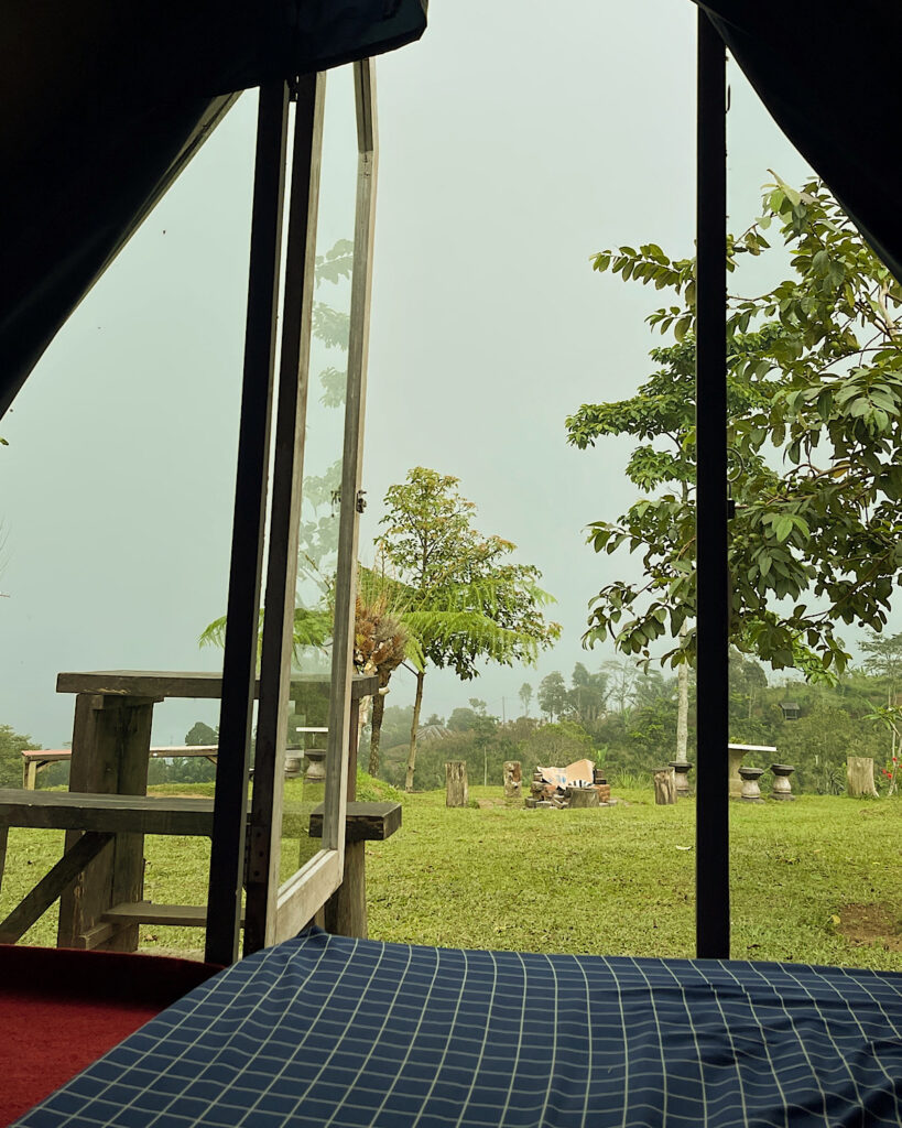 A cosy glamping pod with a view of the countryside on a misty day.