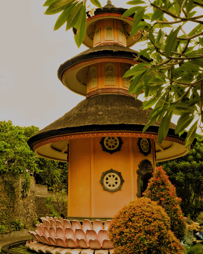 An orange pagoda surrounded by pink lotus decoration.