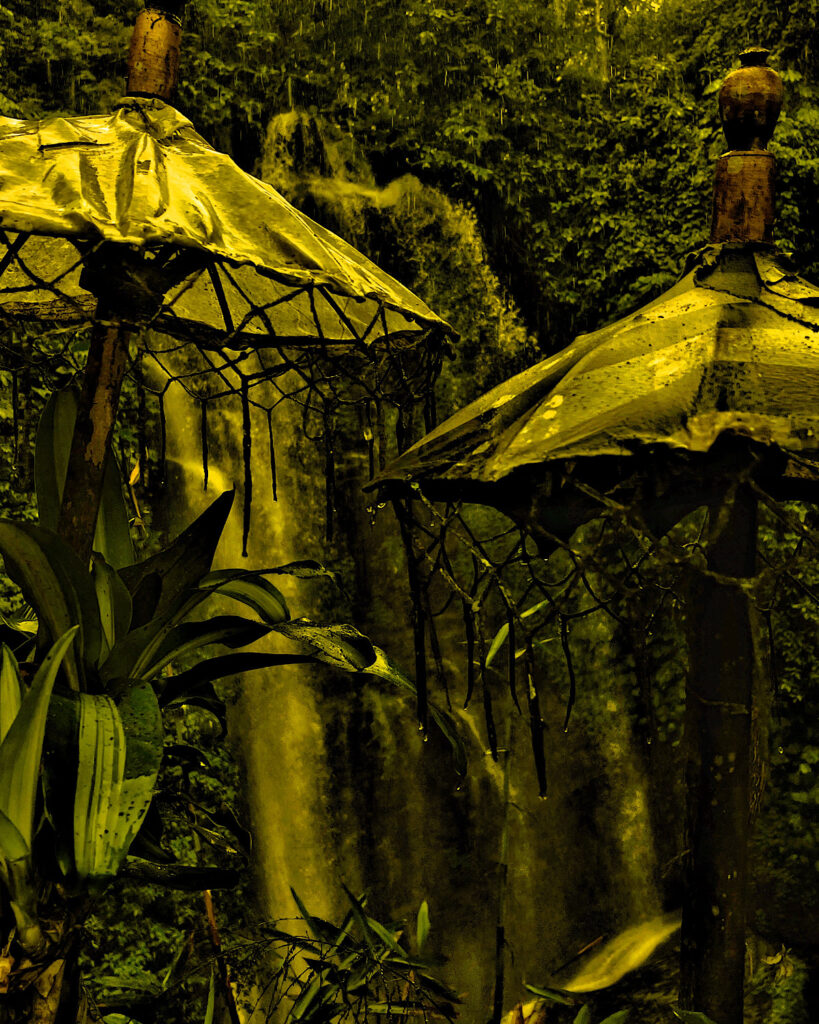 A Hindu offering temple in front of a beautiful waterfall in the jungle.