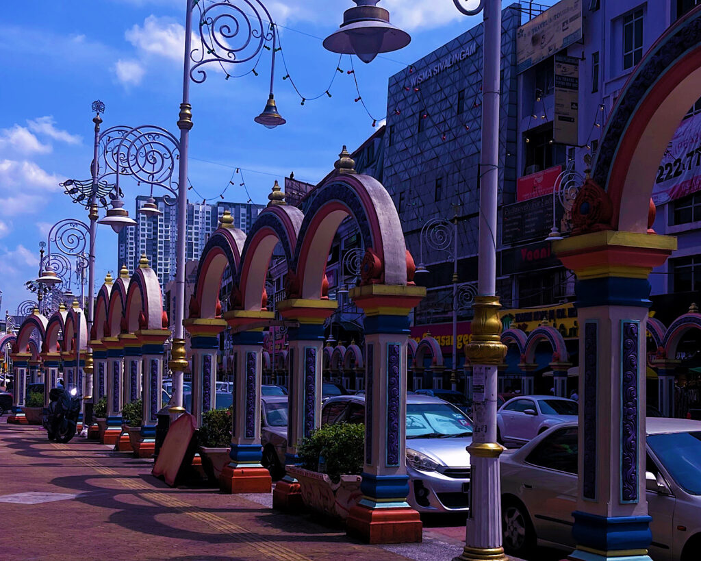 A bustling street with colourful archways and a vibrant atmosphere.