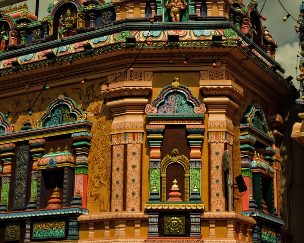 A vibrant temple adorned with numerous intricate patterns, showcasing a lively and colourful architectural design.